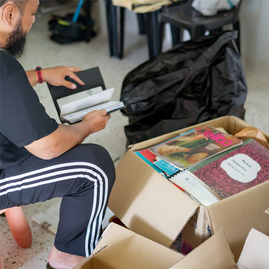 Person sorting through box of books